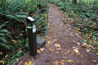 Summit Loop Trail with directional signage capped with a “you are here” trail map
